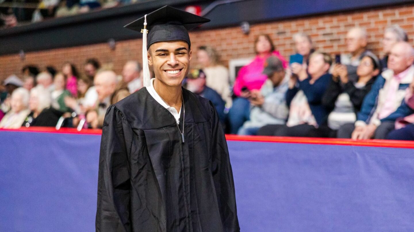 student smiling a commencement 