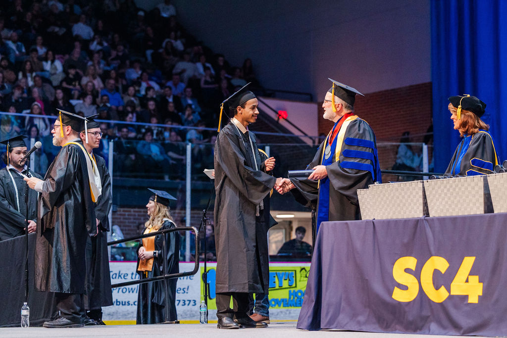 student recieving diploma at commencement 