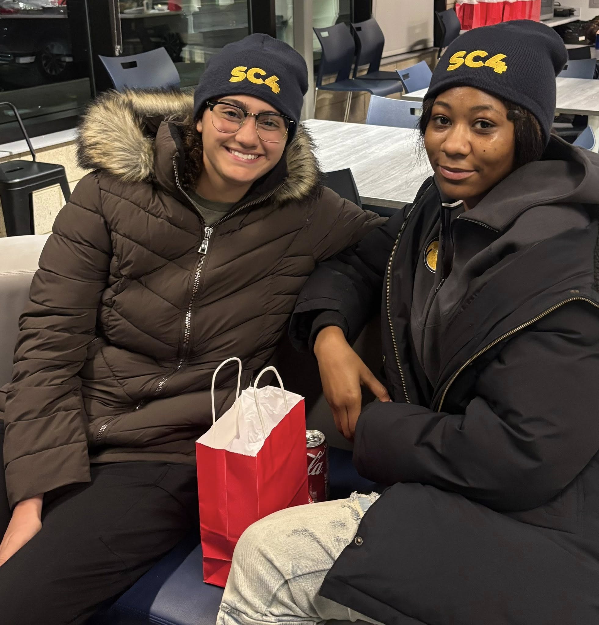Two students sitting in a lobby 